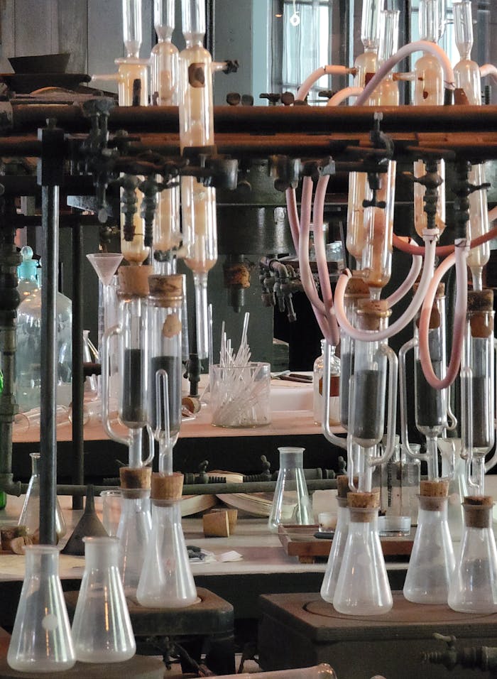 A detailed view of vintage laboratory glassware and equipment in a historical science lab setting.